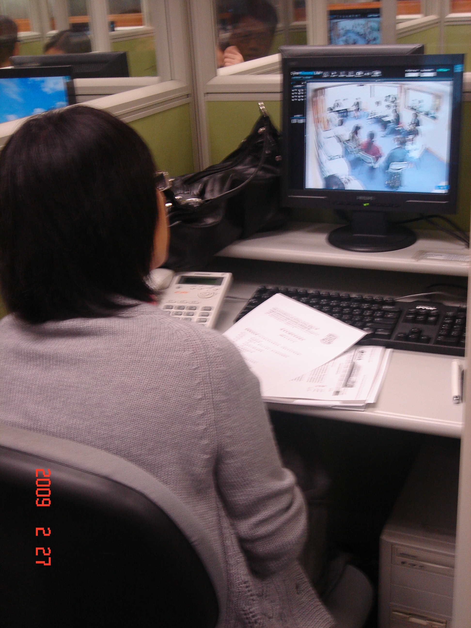 A trainee observing pilot DP discussion on computer